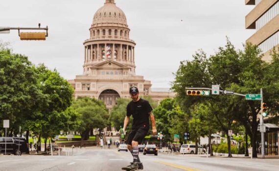 man riding bicycle on road near brown concrete building during daytime